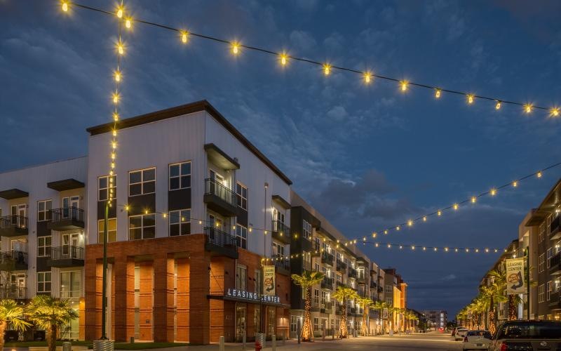 street view of leasing office with stringed lights above street