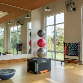 Quick access to state-of-the-art amenities workout studio with equipment and large windows