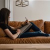 a woman sitting on a couch drawing