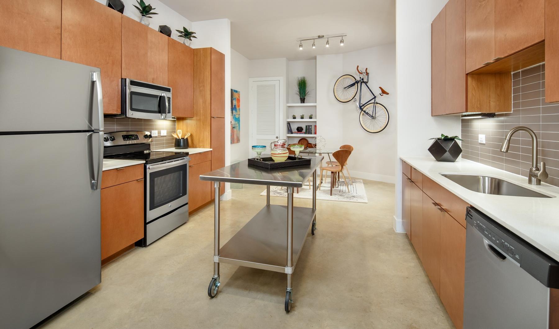 a kitchen with a stainless steel island on wheels