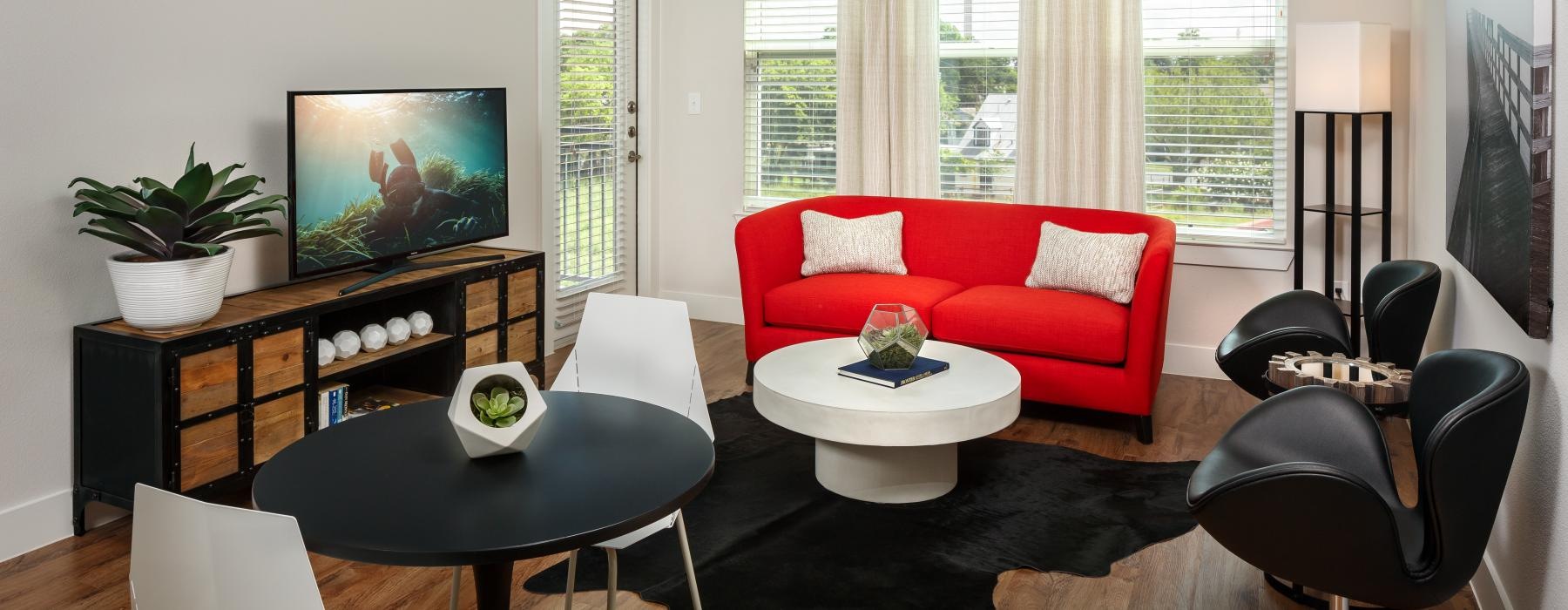 a living room with a tv and couches